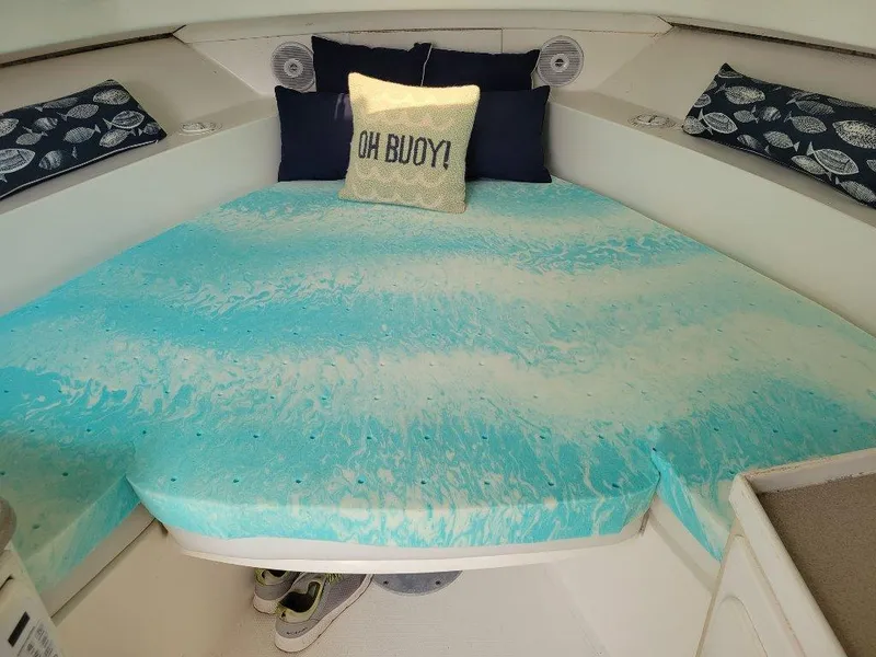 Slide: The Image of 2005 Stamas 290 Express cabin with blue bedding and decorative pillows. - 12
