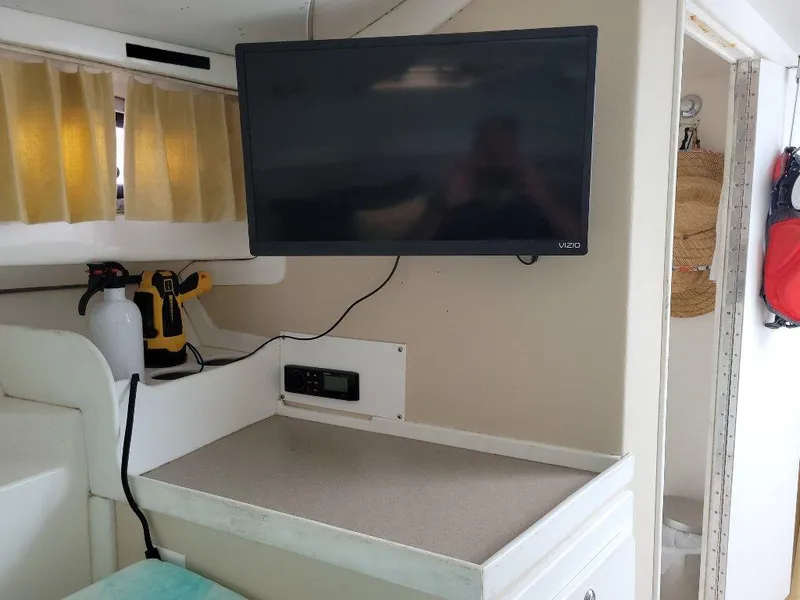 Slide: The Image of Interior of 2005 Stamas 290 Express boat with mounted TV and counter space. - 14