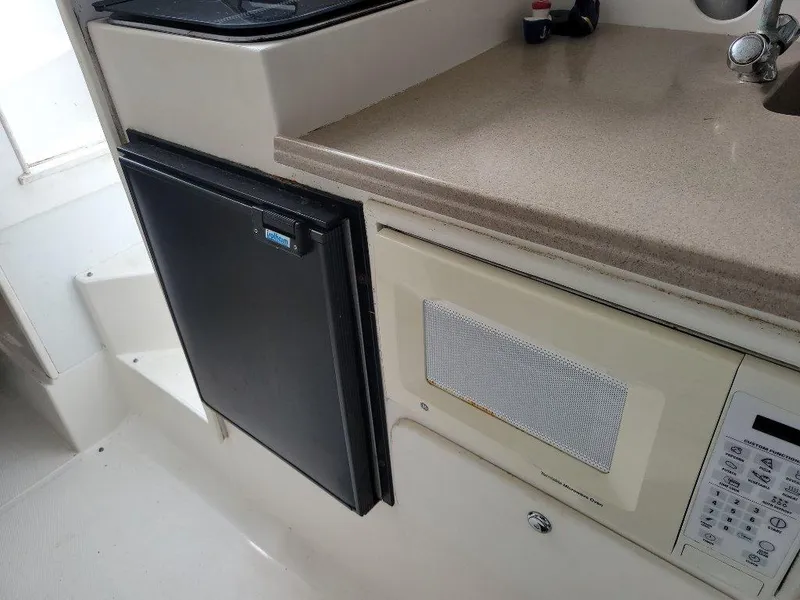 Slide: The Image of 2005 Stamas 290 Express boat interior with microwave and mini fridge. - 15