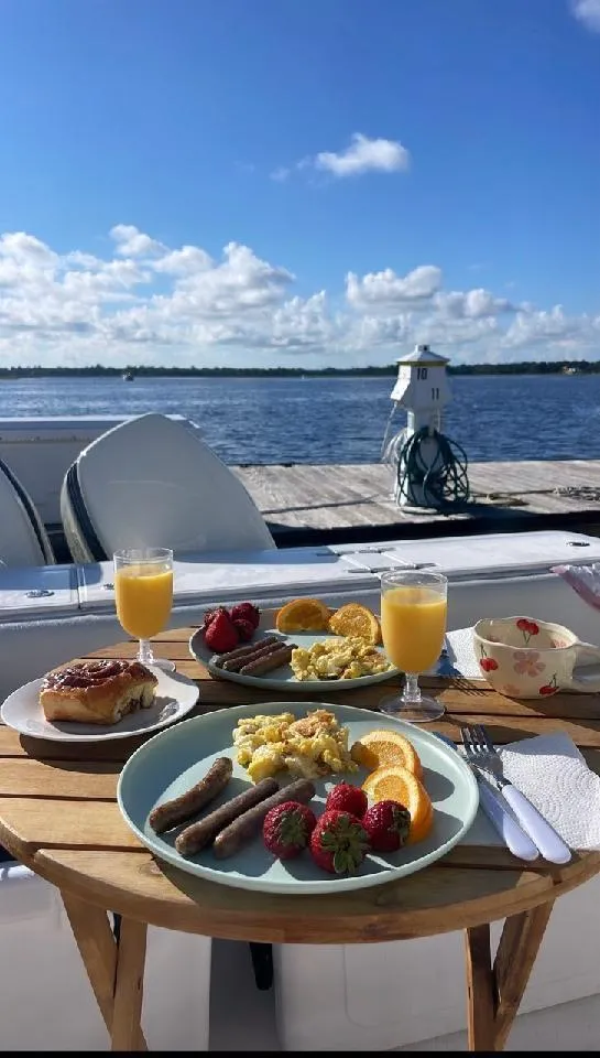 Slide: The Image of Breakfast on a 2005 Stamas 290 Express boat with lake view, featuring fruit and juice. - 19