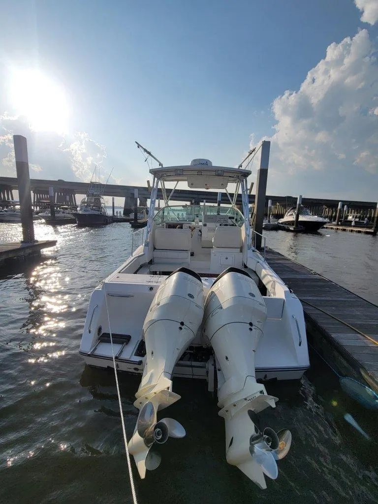 Slide: The Image of 2005 Stamas 290 Express boat docked with twin outboard engines, sunny day. - 5