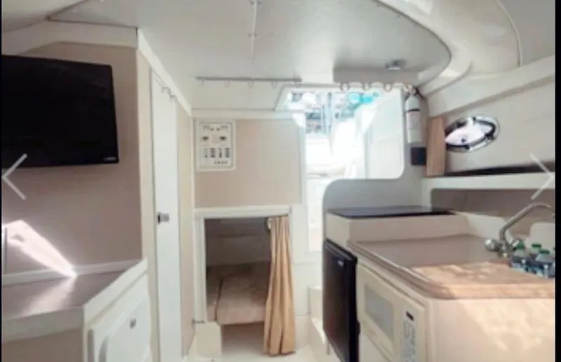 Slide: The Image of Interior of 2005 Stamas 290 Express boat with kitchenette and sleeping area. - 8