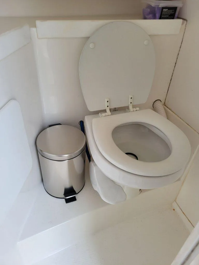 Slide: The Image of 2005 Stamas 290 Express boat bathroom with toilet and trash can. - 9