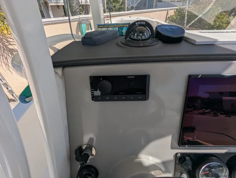 Slide: The Image of Control panel of a 2017 Boston Whaler 240 Dauntless boat with compass and electronics. - 10