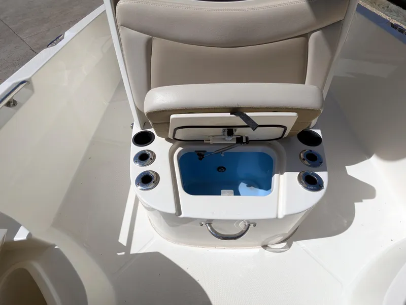 Slide: The Image of 2017 Boston Whaler 240 Dauntless boat interior with open storage compartment and cup holders. - 12