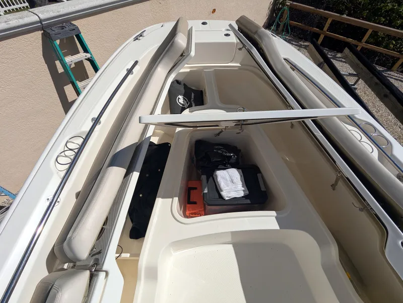 Slide: The Image of 2017 Boston Whaler 240 Dauntless boat interior with storage compartments open. - 14