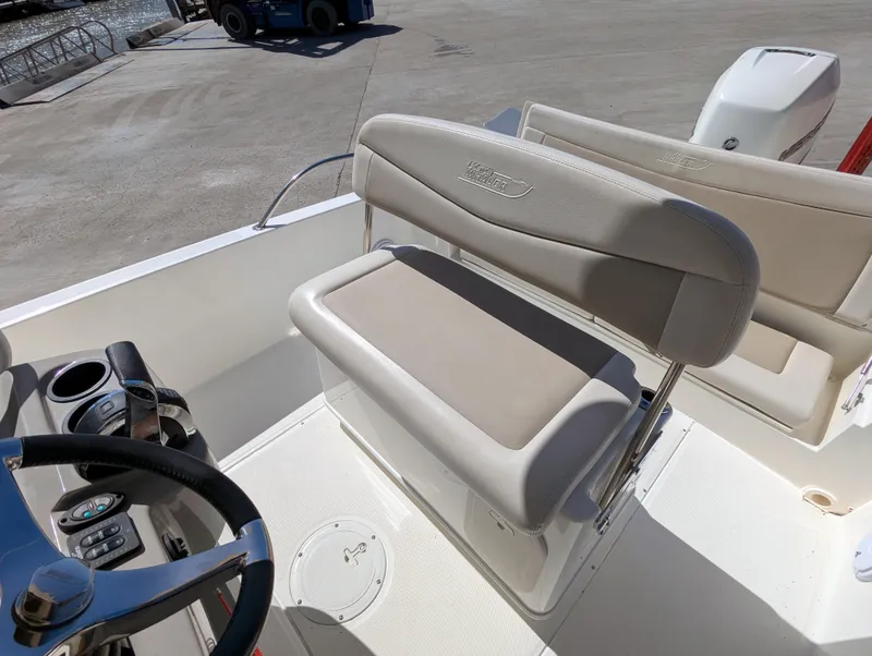 Slide: The Image of 2017 Boston Whaler 240 Dauntless boat interior with steering wheel and seating. - 18
