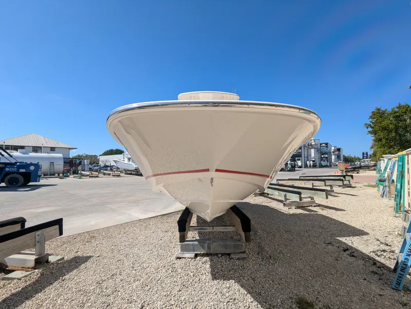 Slide: The Image of 2017 Boston Whaler 240 Dauntless boat on dry dock under clear blue sky. - 2