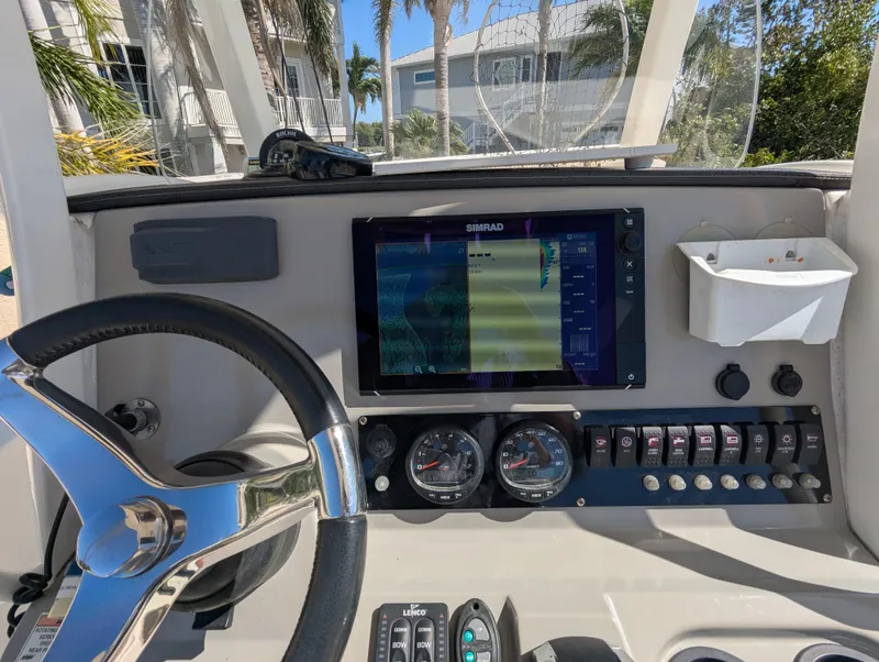 Slide: The Image of 2017 Boston Whaler 240 Dauntless dashboard with steering wheel and navigation display. - 6