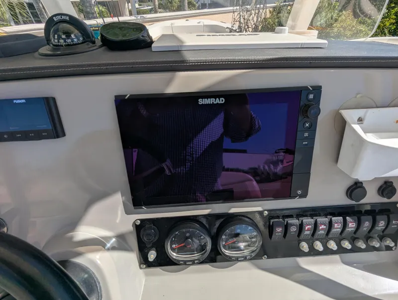Slide: The Image of Control panel of a 2017 Boston Whaler 240 Dauntless with Simrad display and gauges. - 8