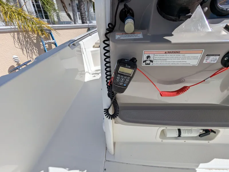 Slide: The Image of 2017 Boston Whaler 240 Dauntless boat console with radio and safety instructions. - 9