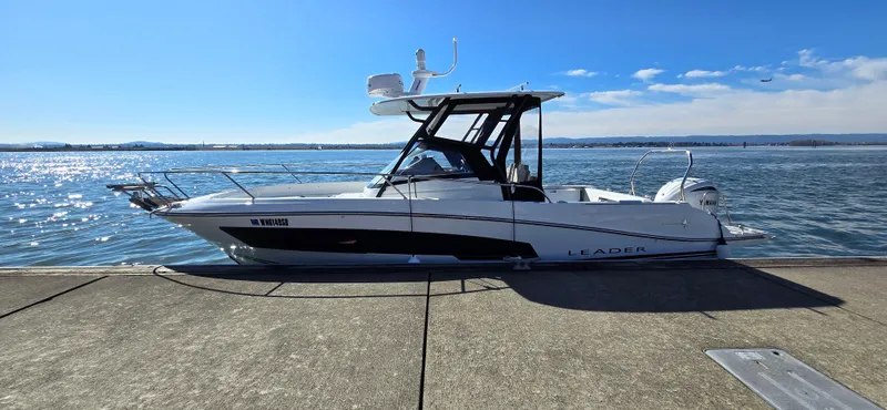 The Image of 2022 Leader 7.5 WA boat docked by the water on a sunny day. - 0