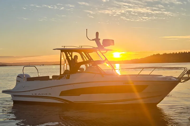 Slide: The Image of 2022 Leader 7.5 wa boat cruising at sunset on calm waters. - 1