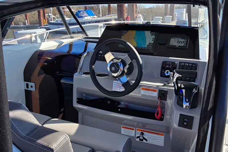 Slide: The Image of 2022 Leader 7.5 WA boat cockpit with steering wheel and navigation display. - 11