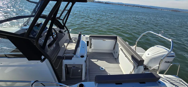 Slide: The Image of 2022 Leader 7.5 WA boat interior with Yamaha engine on calm water. - 13