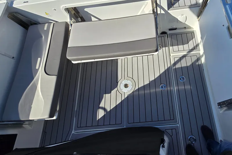 Slide: The Image of Interior view of 2022 Leader 7.5 wa boat, featuring cushioned seating and sleek flooring. - 14