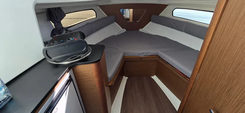 Slide: The Image of Interior of 2022 Leader 7.5 WA boat with cozy seating and modern amenities. - 18