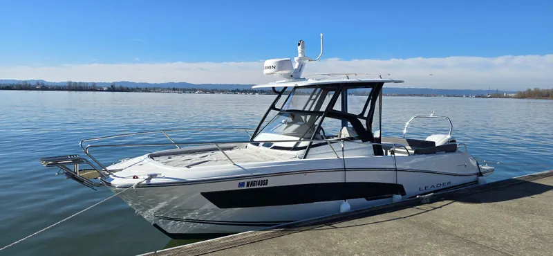 Slide: The Image of 2022 Leader 7.5 WA boat docked on calm water under clear blue sky. - 4