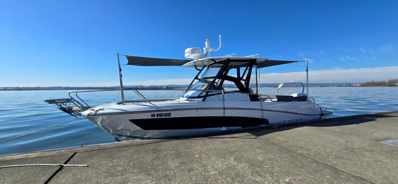 Slide: The Image of 2022 Leader 7.5 WA boat docked on a sunny day by the water. - 5