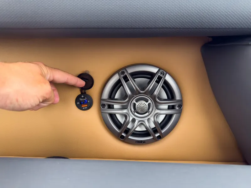 Slide: The Image of Hand adjusting speaker and USB port on 2025 Godfrey Sweetwater 22' Split Bench Tritoon. - 10