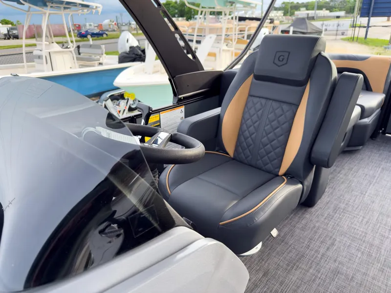 Slide: The Image of Captain's chair on 2025 Godfrey Sweetwater 22' Split Bench Tritoon, featuring luxurious design and comfort. - 12