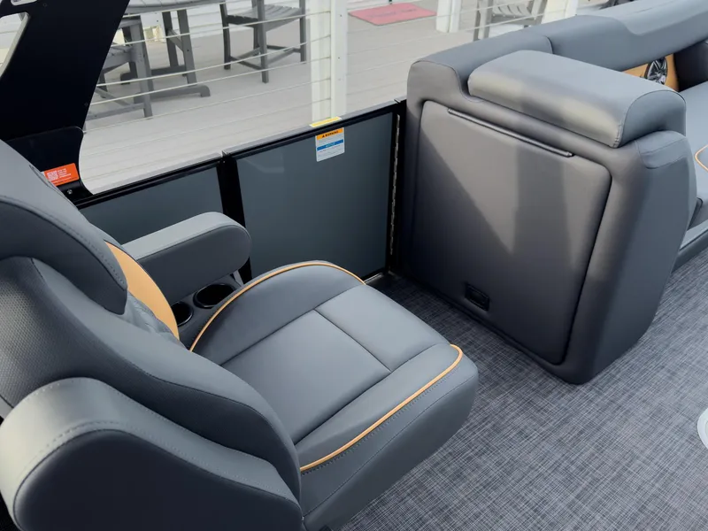 Slide: The Image of 2025 Godfrey Sweetwater 22' Tritoon interior with sleek gray seating and modern design. - 18