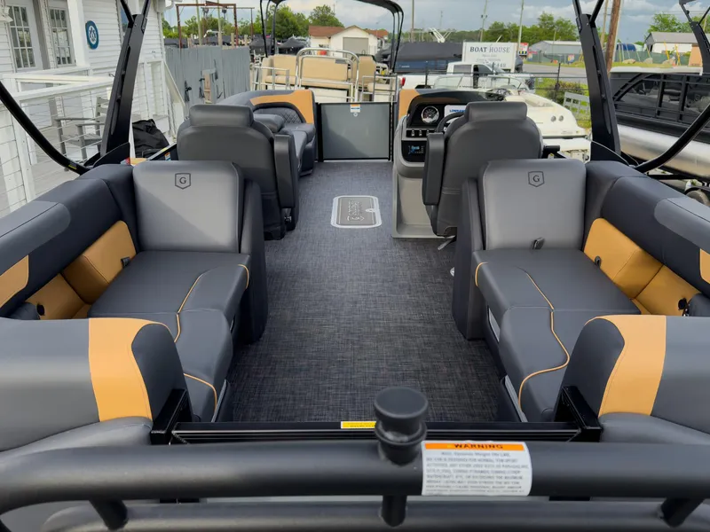 Slide: The Image of 2025 Godfrey Sweetwater 22' Tritoon interior with split bench seating and modern design. - 22