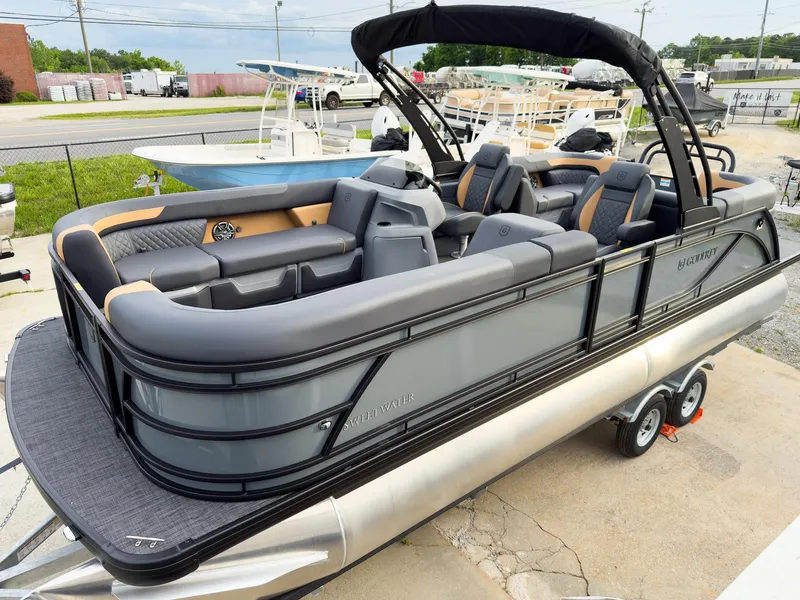 Slide: The Image of 2025 Godfrey Sweetwater 22' Split Bench Tritoon, sleek design, luxury seating, on trailer. - 3