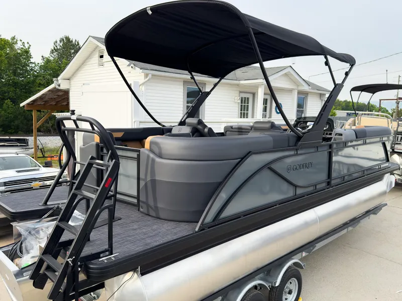 Slide: The Image of 2025 Godfrey Sweetwater 22' Split Bench Tritoon with canopy, parked on trailer. - 4