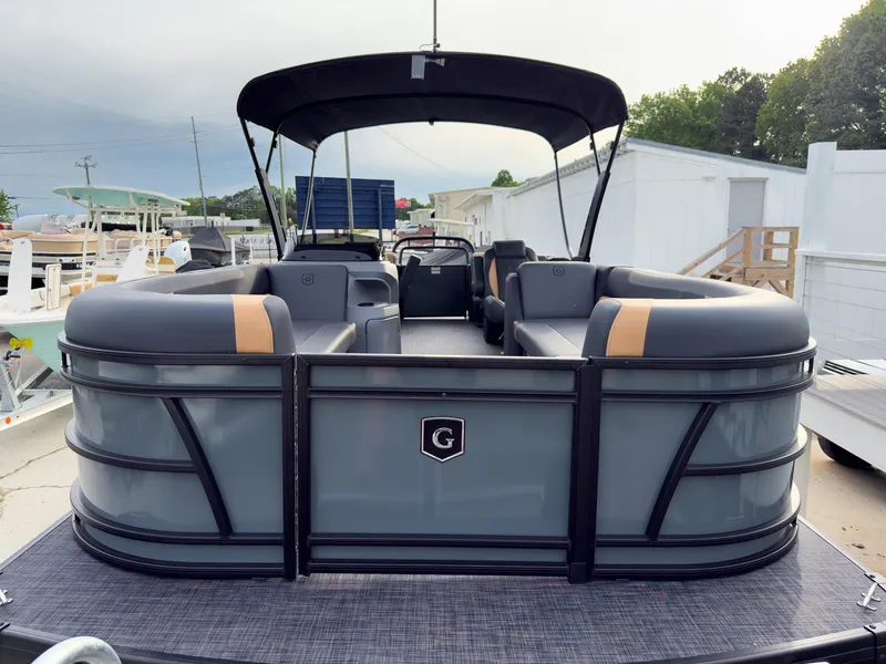 Slide: The Image of 2025 Godfrey Sweetwater 22' Split Bench Tritoon with sleek design and spacious seating. - 5