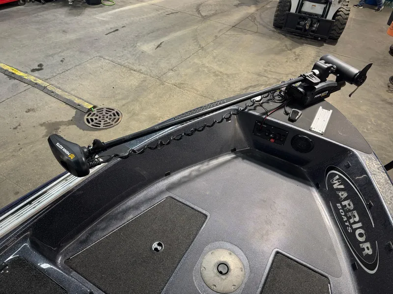 Slide: The Image of 2016 Warrior V2121 boat deck with trolling motor in a garage setting. - 10