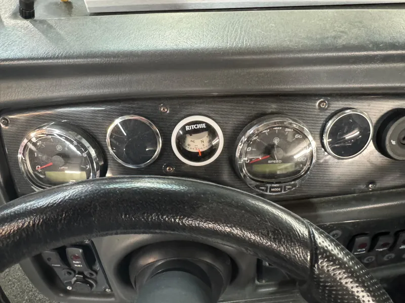 Slide: The Image of Dashboard of a 2016 Warrior V2121 boat with gauges and steering wheel. - 6