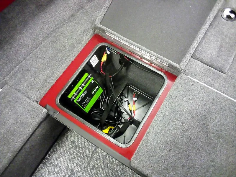 Slide: The Image of Battery compartment of 2025 Ranger VS1665 SC boat, featuring wiring and storage. - 13