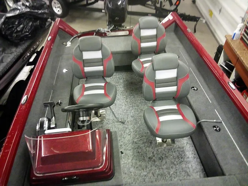 Slide: The Image of 2025 Ranger VS1665 SC boat interior with four gray and red seats, steering console, and carpeted floor. - 17