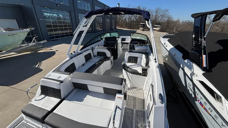 Slide: The Image of 2025 Monterey M65 boat with spacious seating and modern design, docked outdoors. - 13