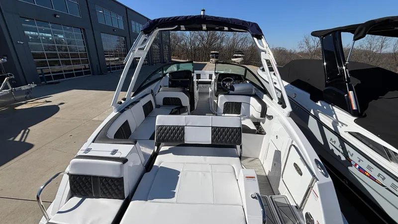 Slide: The Image of 2025 Monterey M65 boat with sleek white interior and modern design, docked outdoors. - 16