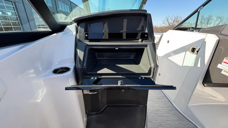 Slide: The Image of 2025 Monterey M65 boat interior storage compartment with open hatch, showcasing sleek design. - 19