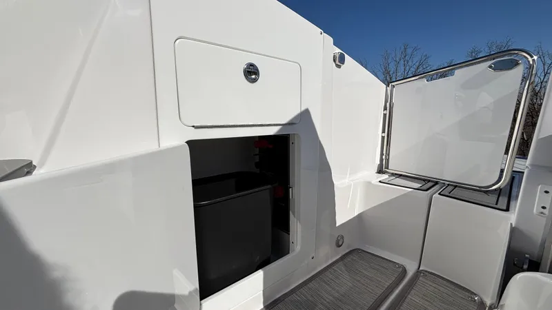 Slide: The Image of Monterey M65 2025 boat storage compartment with open hatch, showcasing sleek design. - 21