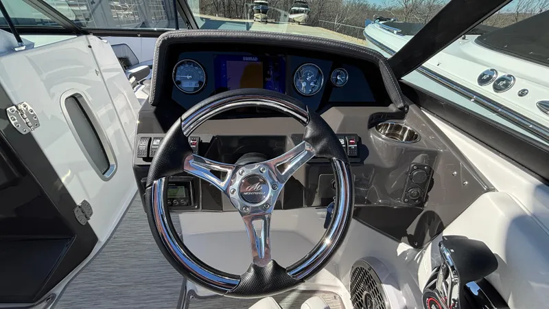 Slide: The Image of Steering wheel and dashboard of a 2025 Monterey M65 boat, featuring modern controls and gauges. - 39