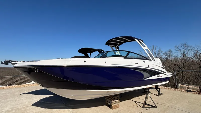 Slide: The Image of 2025 Monterey M65 boat on display, blue and white design, clear sky background. - 4