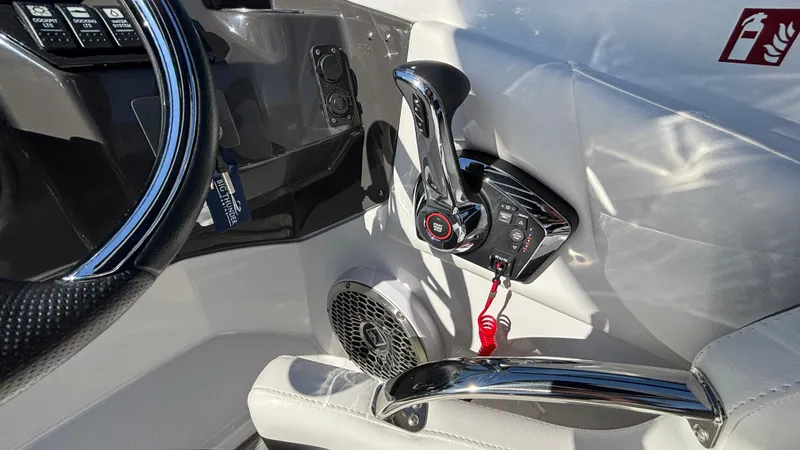 Slide: The Image of 2025 Monterey M65 boat interior with steering wheel, throttle controls, and speaker. - 40