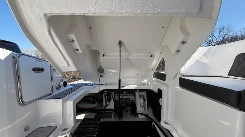 Slide: The Image of Open engine compartment of a 2025 Monterey M65 boat under clear blue sky. - 47