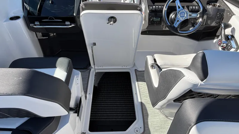Slide: The Image of Interior of 2025 Monterey M65 boat with open storage compartment and modern seating. - 49