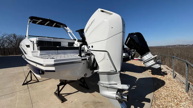 Slide: The Image of 2025 Monterey M65 boat with dual outboard engines on display outdoors. - 8