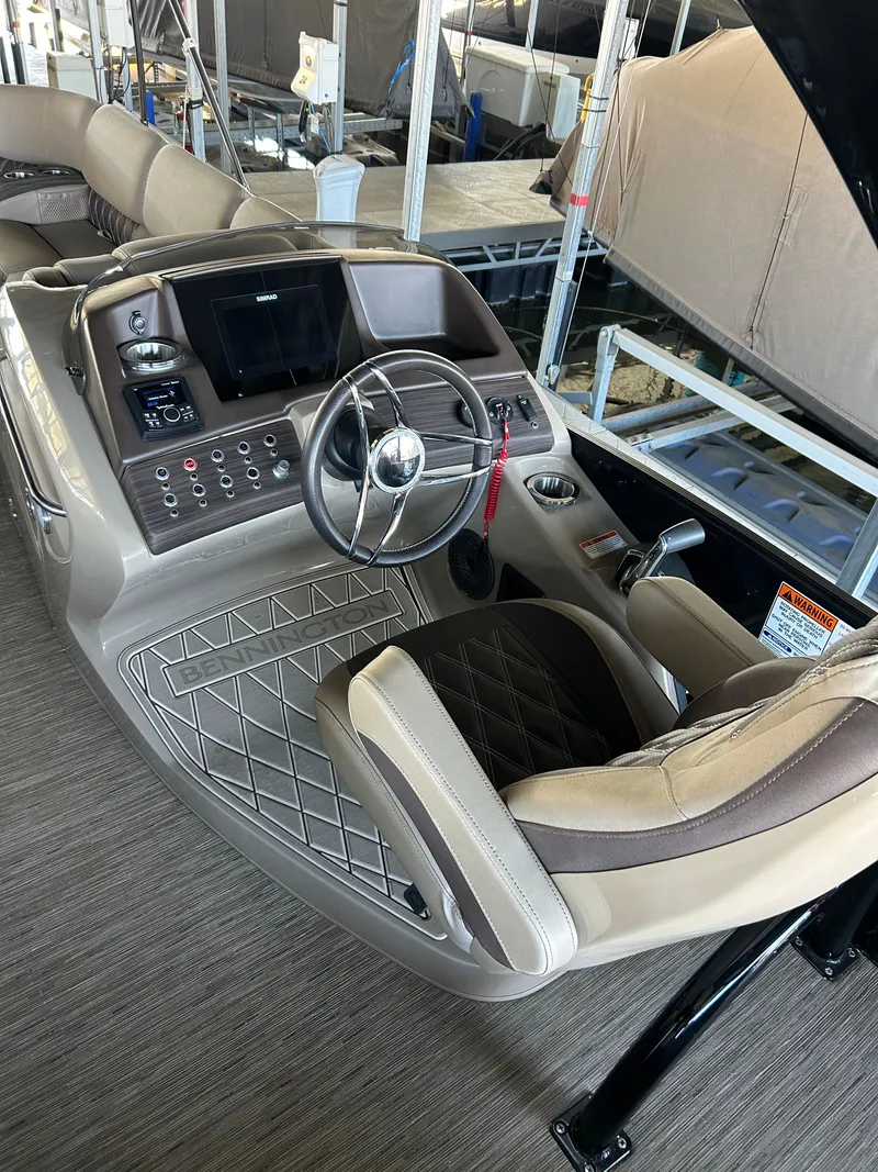Slide: The Image of 2023 Bennington 25 QSBA boat interior with steering console and seating. - 6