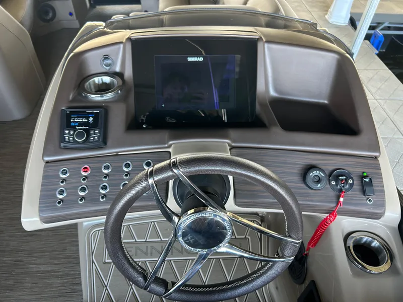 Slide: The Image of 2023 Bennington 25 QSBA boat dashboard with steering wheel and control panel. - 7