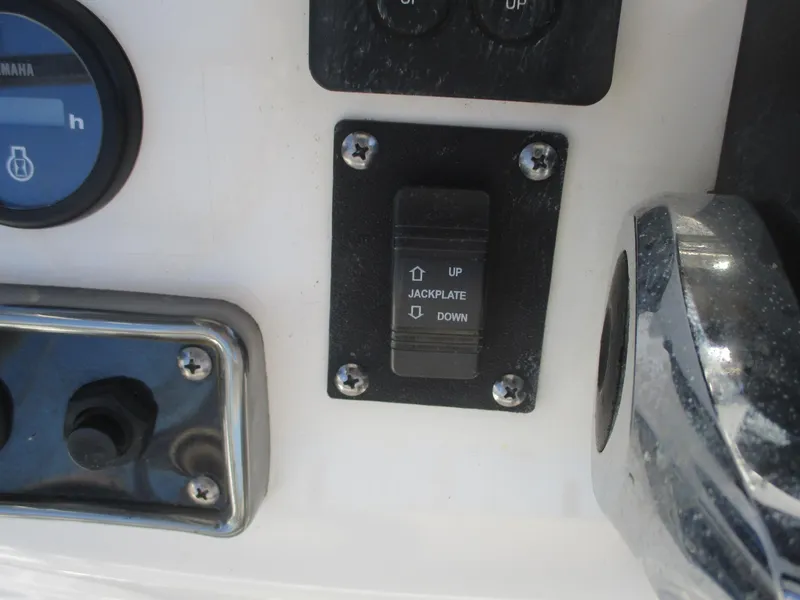 Slide: The Image of Control panel of 2018 NauticStar 2400 Sport boat with jackplate switch. - 14