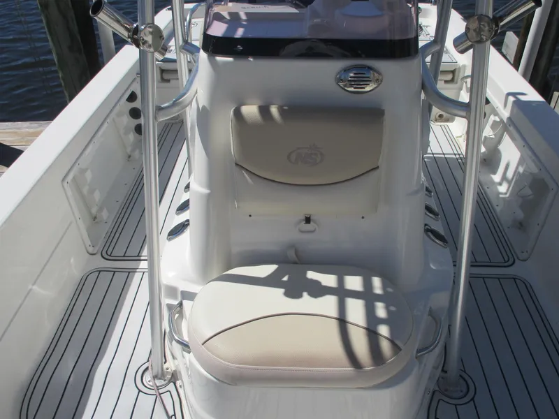 Slide: The Image of 2018 NauticStar 2400 Sport boat interior with seating and console. - 16