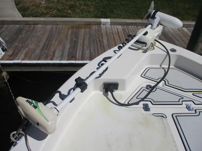 Slide: The Image of 2018 NauticStar 2400 Sport boat with trolling motor at dock. - 3