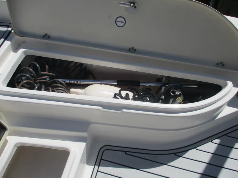 Slide: The Image of Storage compartment on a 2018 NauticStar 2400 Sport boat, showing coiled equipment. - 6